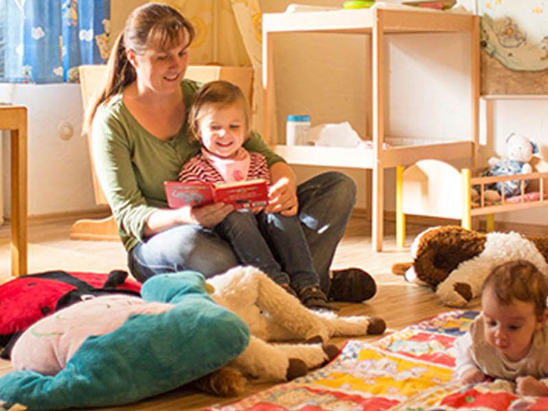 Mama spiel mit ihren Kinder im Spielraum.